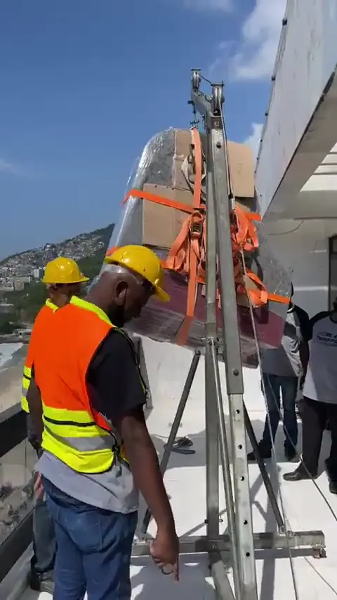 Móvel preso com cintas sendo içado por guincho